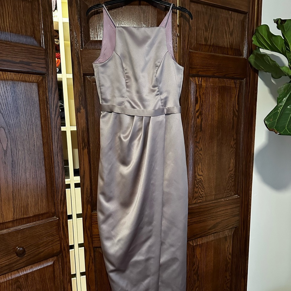 Long, light purple satin bridesmaid dress.